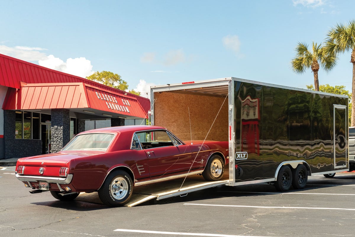 Red car loading into black XLT Pro Car Hauler