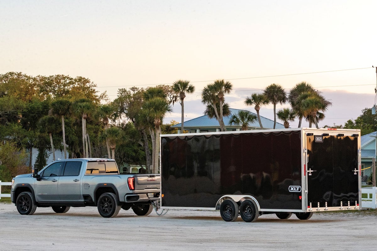 Sunset view of black XLT Pro Car Hauler attached to a truck