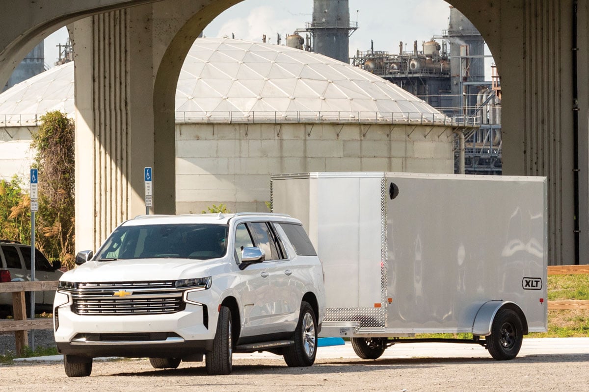 White SUV towing 6 Wide LXT Gray Tailer