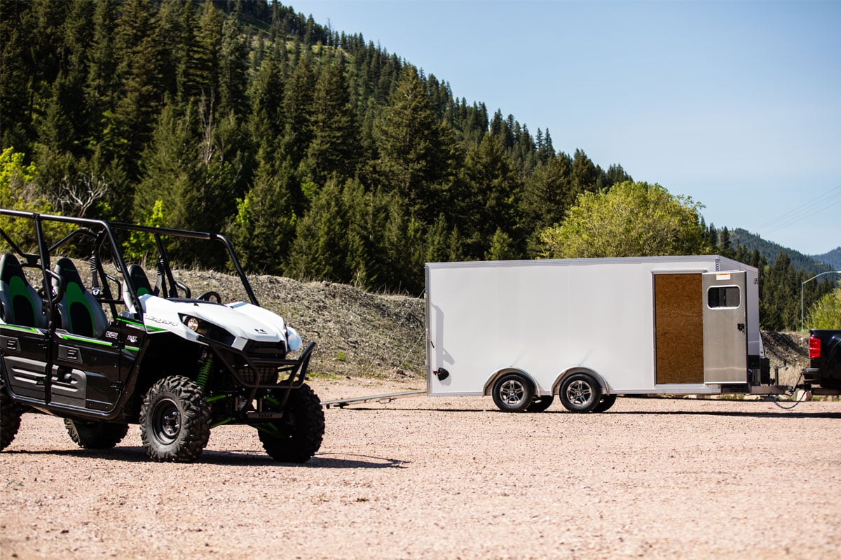 Atv And White Trailer At Mountain